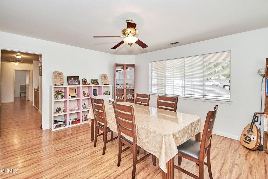 9527 Riggins Road Phelan, CA 92371 - Photo 11 of 49 a view of a dining room with furniture window and wooden floor