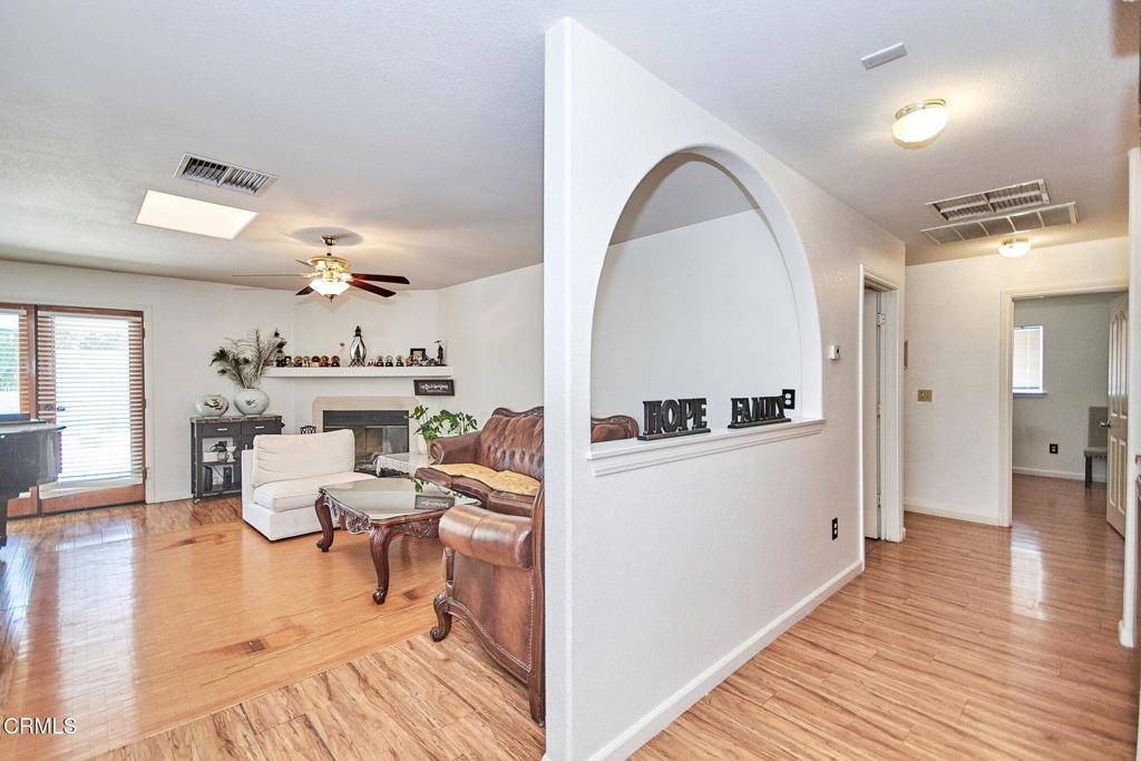9527 Riggins Road Phelan, CA 92371 - Photo 12 of 49 a view of living room and kitchen with wooden floor