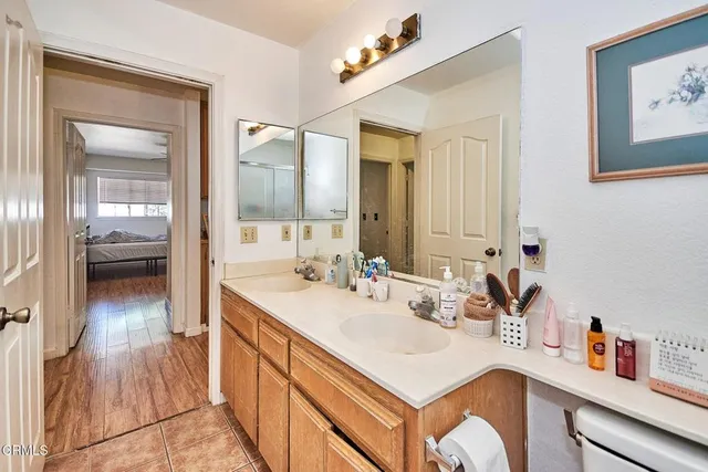 a en suite bathroom with a sink double vanity and a mirror