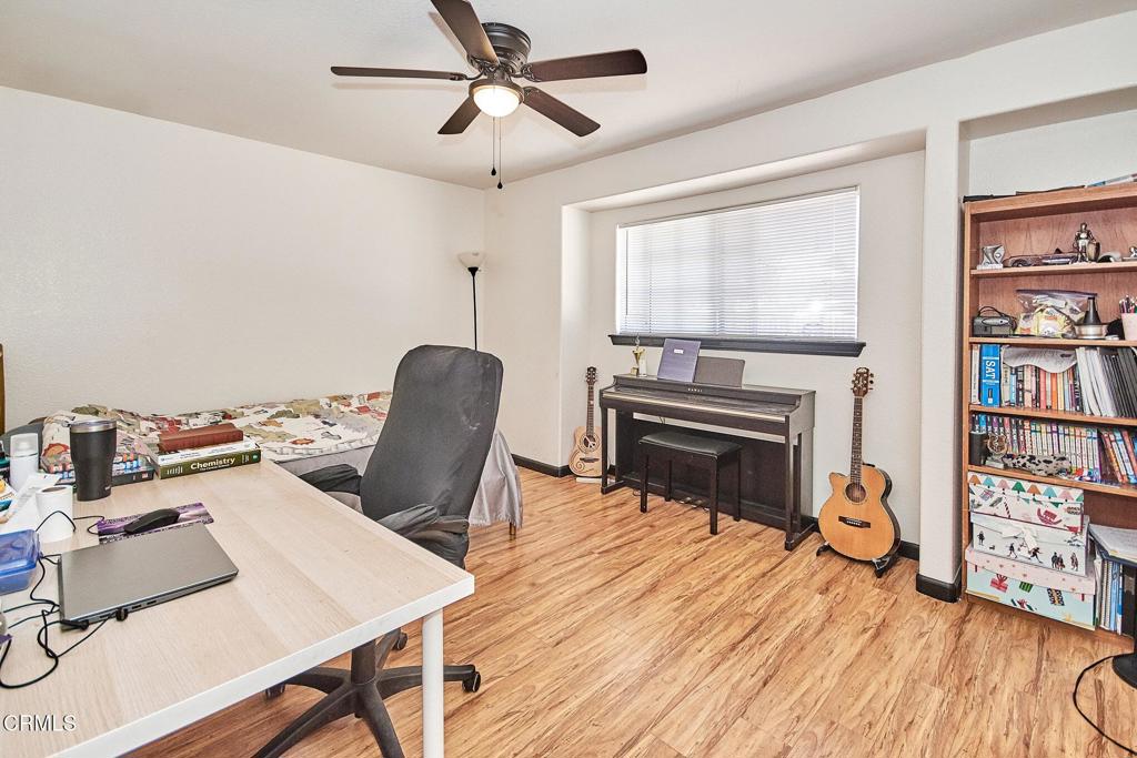 9527 Riggins Road Phelan, CA 92371 - Photo 17 of 49 a living room with furniture a fireplace and a flat screen tv