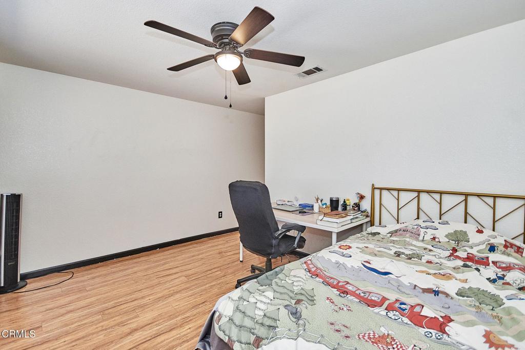 9527 Riggins Road Phelan, CA 92371 - Photo 19 of 49 a view of a workspace with furniture and a wooden floor