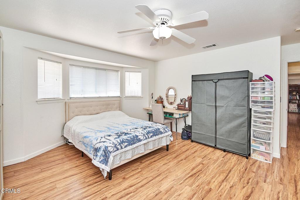 9527 Riggins Road Phelan, CA 92371 - Photo 23 of 49 a bedroom with a bed dresser and a window