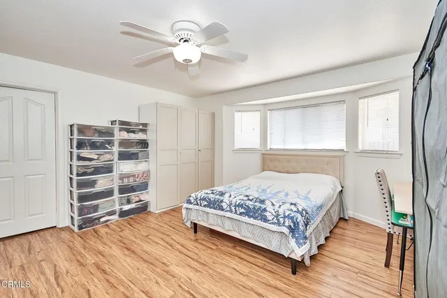 a bedroom with a bed closet and a window