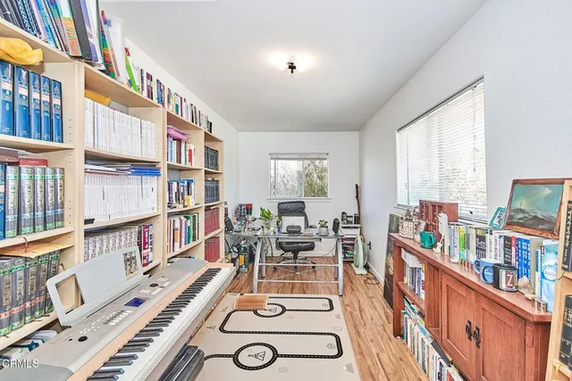a living room with lots of furniture and a book shelf