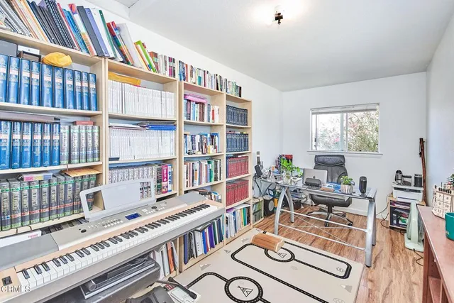 a living room with furniture and a book shelf