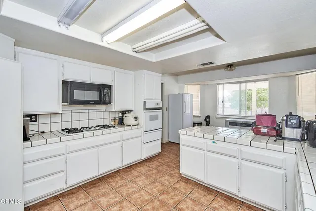 a kitchen that has a sink and a stove in it