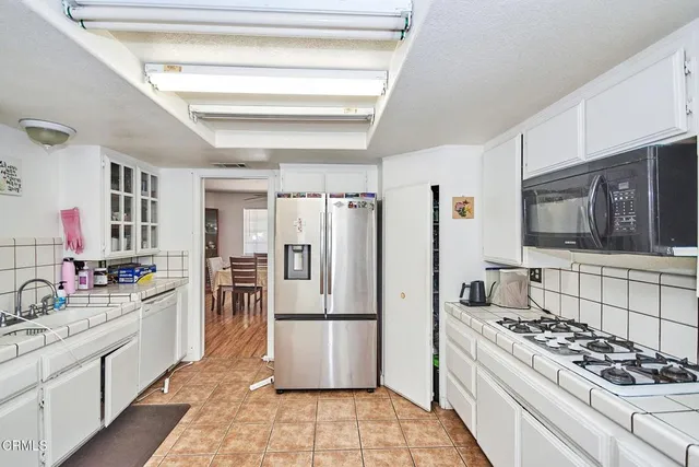 a kitchen with stainless steel appliances a refrigerator stove and sink
