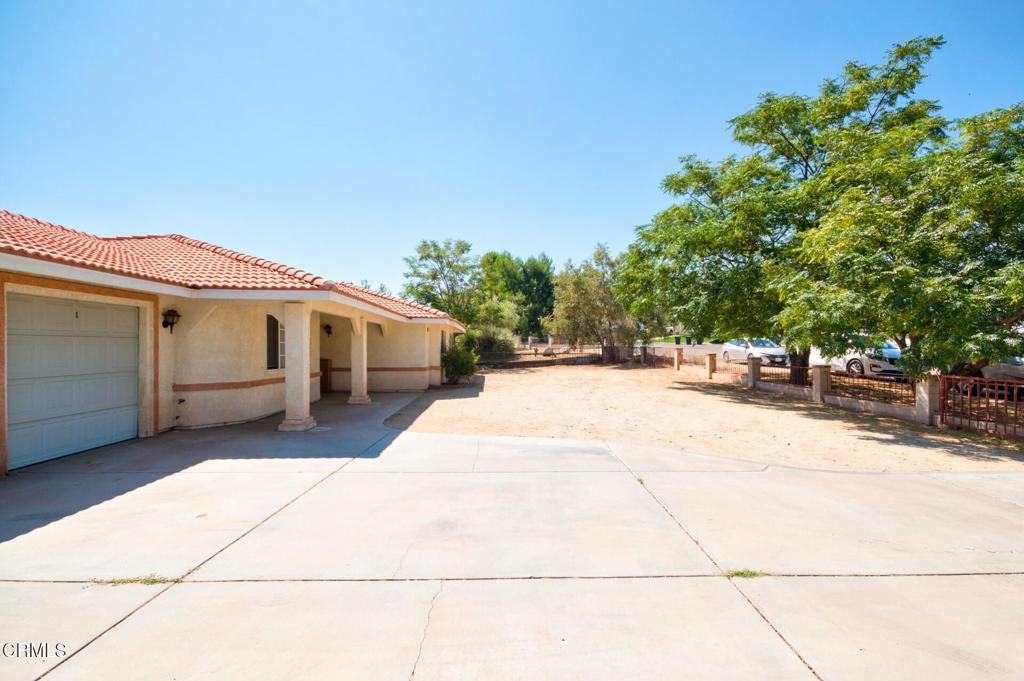 9527 Riggins Road Phelan, CA 92371 - Photo 40 of 49 a front view of a house with a garage