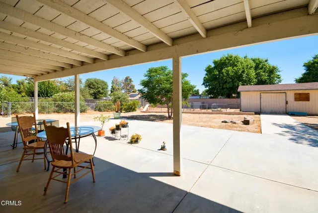 a view of a dirt road and a building
