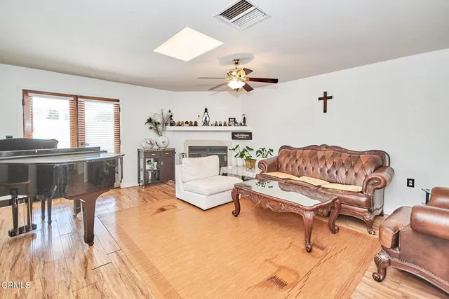 a living room with furniture a fireplace and a table