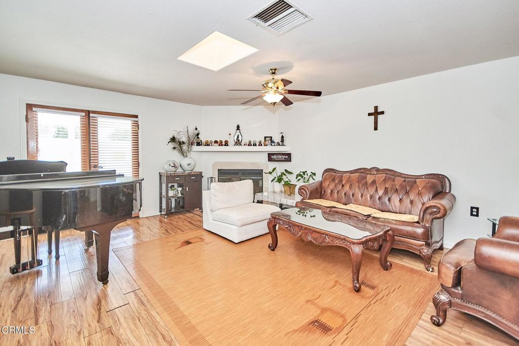 9527 Riggins Road Phelan, CA 92371 - Photo 7 of 49 a living room with furniture a fireplace and a table