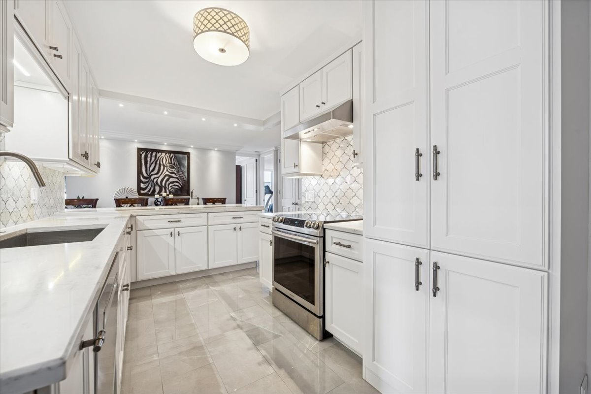 200 East Delaware Place, Unit 20A Chicago, IL 60611 - Photo 14 of 46 a kitchen with white cabinets and white appliances