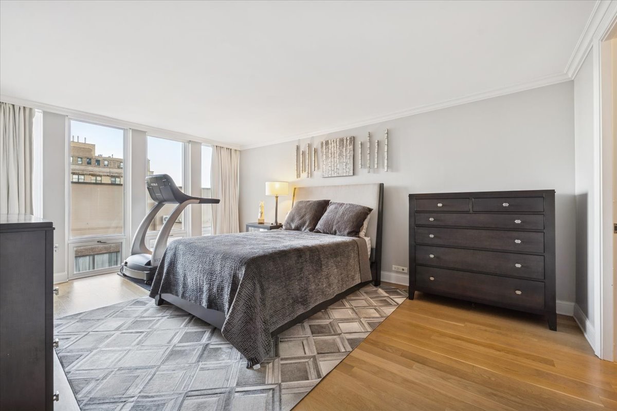 200 East Delaware Place, Unit 20A Chicago, IL 60611 - Photo 15 of 46 a bedroom with a bed and a dresser