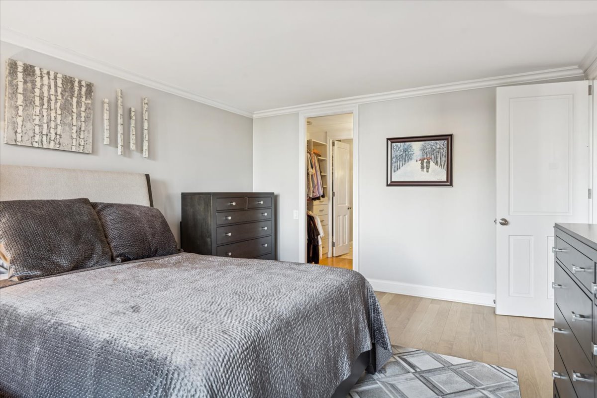 200 East Delaware Place, Unit 20A Chicago, IL 60611 - Photo 16 of 46 a large bedroom with a bed and wooden floor