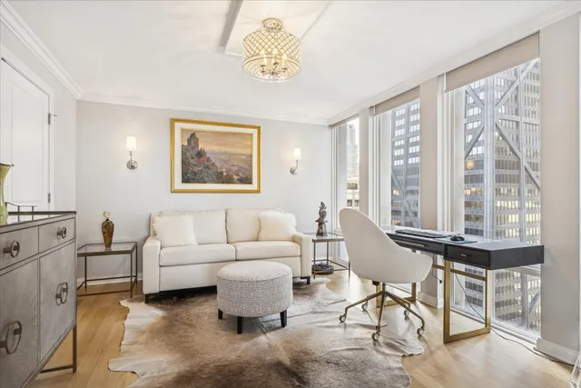 a living room with furniture and large windows