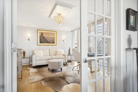 a living room with furniture and a floor to ceiling window