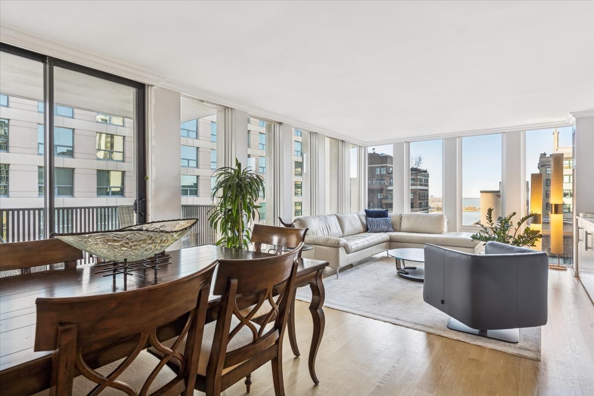200 East Delaware Place, Unit 20A Chicago, IL 60611 - Photo 29 of 46 a view of a dining room with furniture large windows and wooden floor