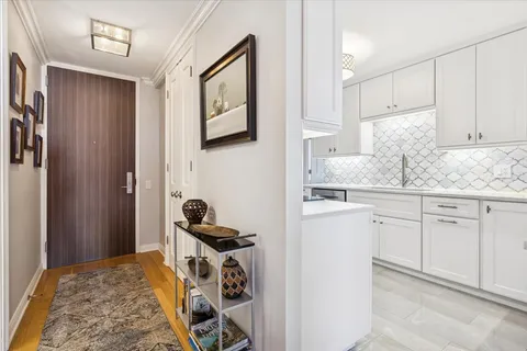 a kitchen with sink cabinets and stove top oven