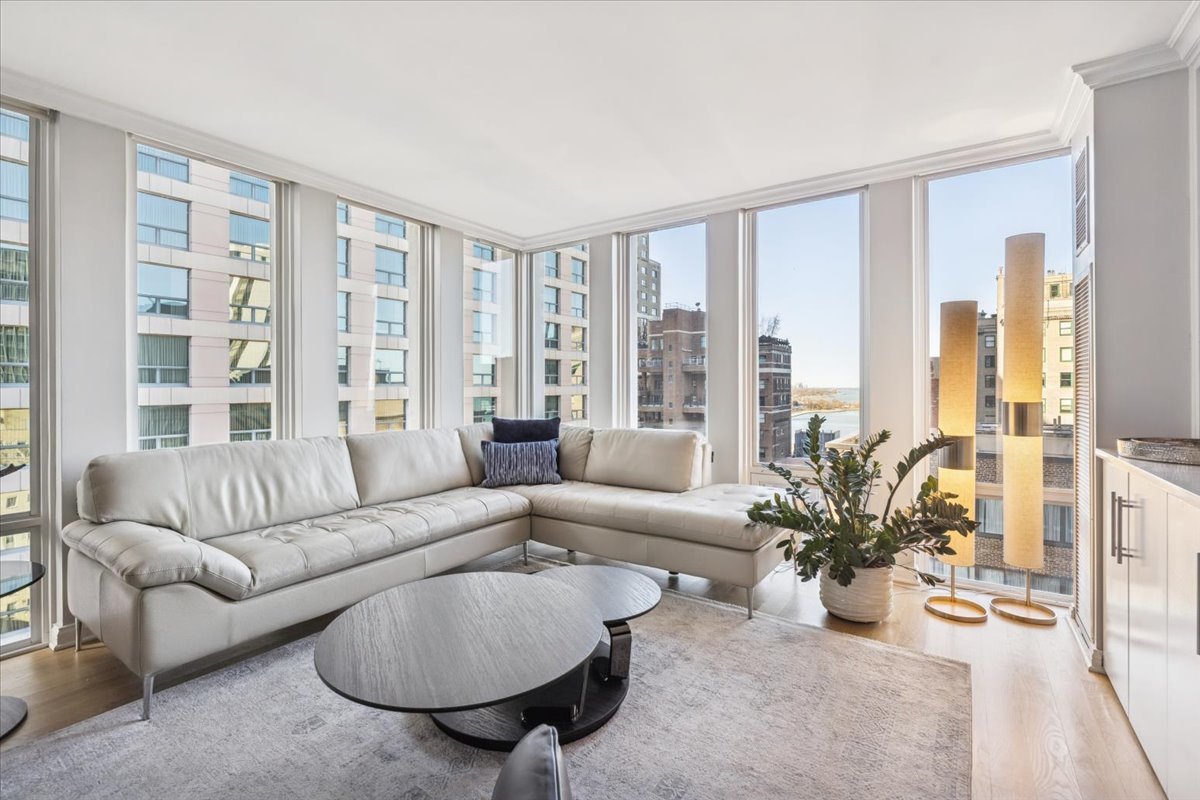 200 East Delaware Place, Unit 20A Chicago, IL 60611 - Photo 32 of 46 a living room with furniture and floor to ceiling windows