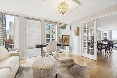 a living room with furniture a dining table and a large window