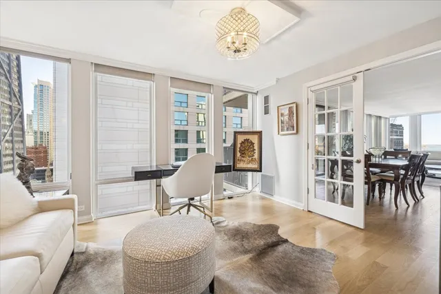 a living room with furniture a dining table and a large window