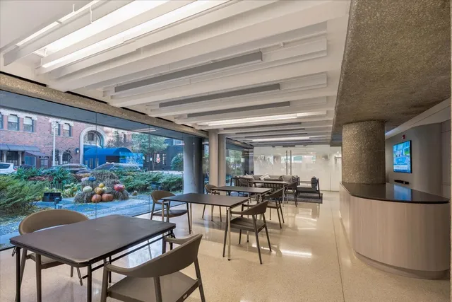 a view of a dining room with furniture and a floor to ceiling window
