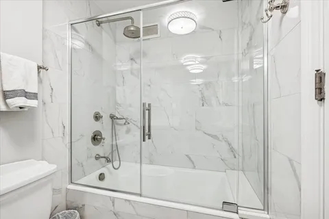 a bathroom with a shower and a toilet