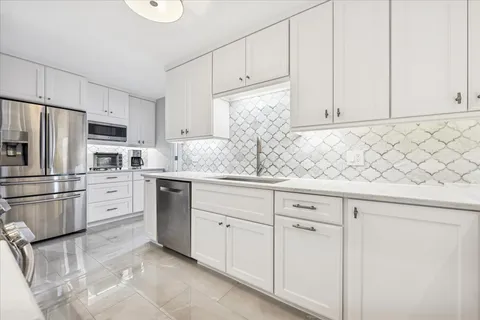 a kitchen with appliances cabinets and a sink