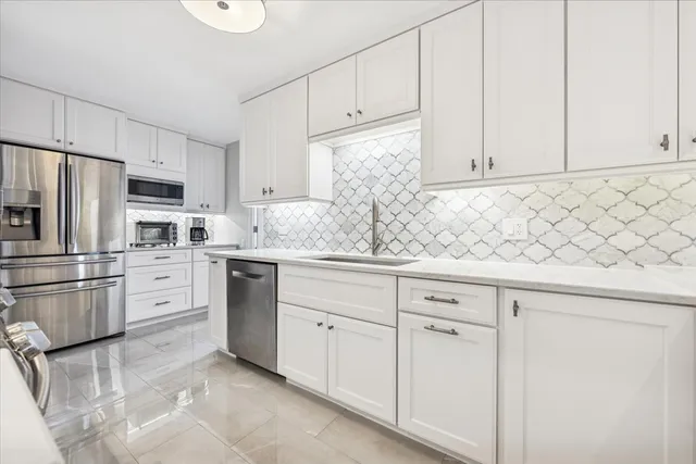 a kitchen with appliances cabinets and a sink