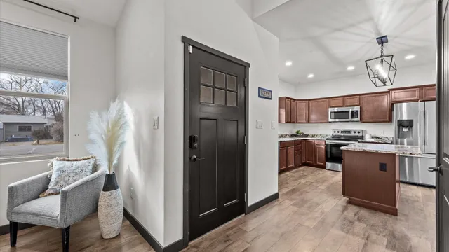 a kitchen with stainless steel appliances granite countertop a refrigerator a sink a stove and a cabinets