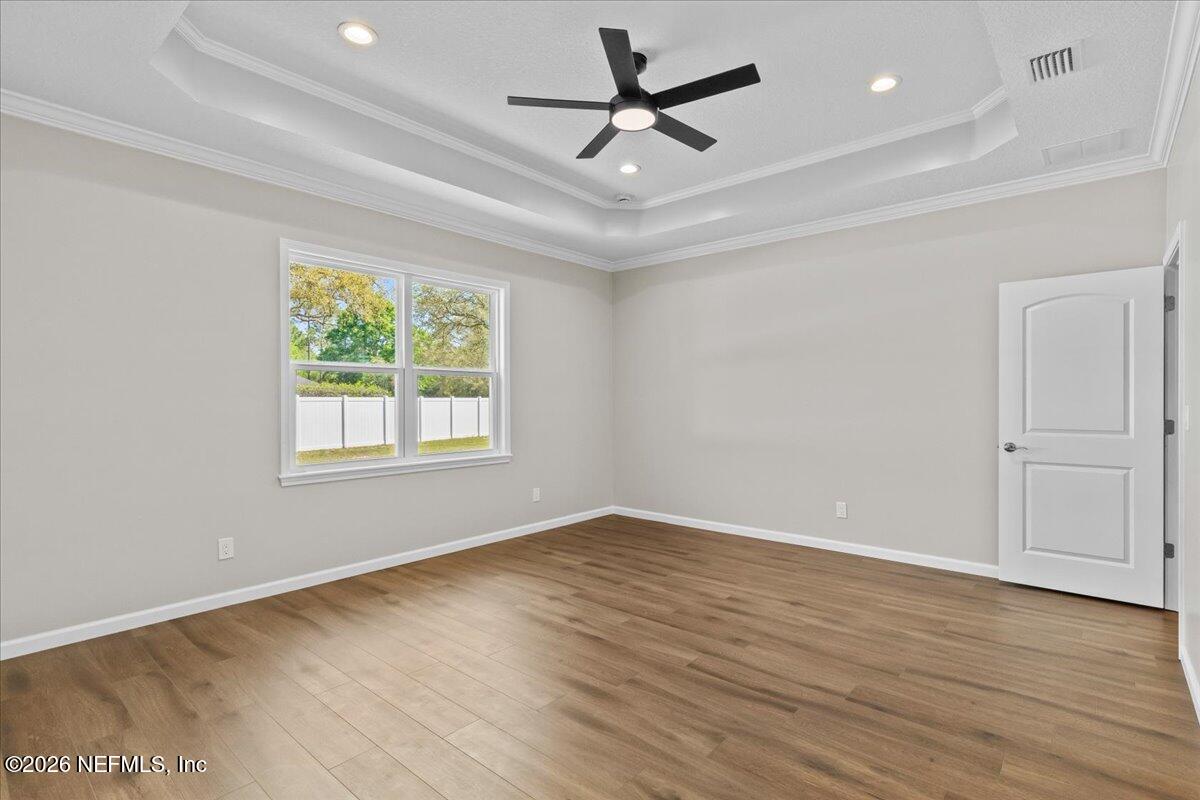 2462 Viola Street Middleburg, FL 32068 - Photo 17 of 61 an empty room with wooden floor fan and windows