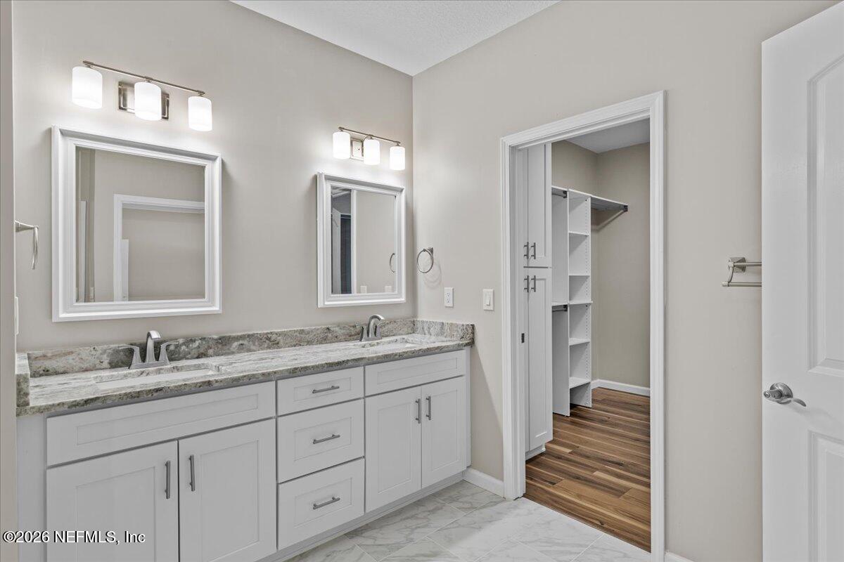 2462 Viola Street Middleburg, FL 32068 - Photo 23 of 61 a bathroom with double vanity sinks and a mirror