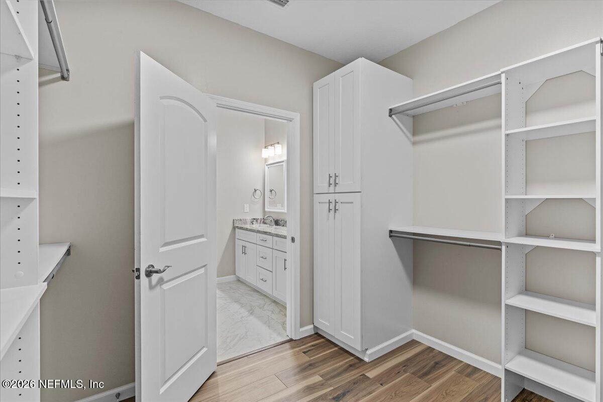 2462 Viola Street Middleburg, FL 32068 - Photo 25 of 61 a view of walk in closet with empty racks