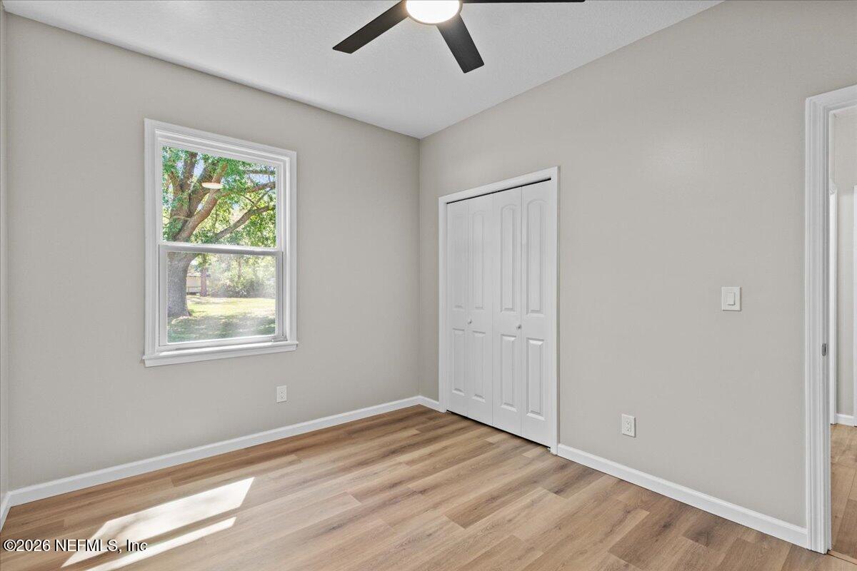 2462 Viola Street Middleburg, FL 32068 - Photo 29 of 61 a view of an empty room with wooden floor and a window