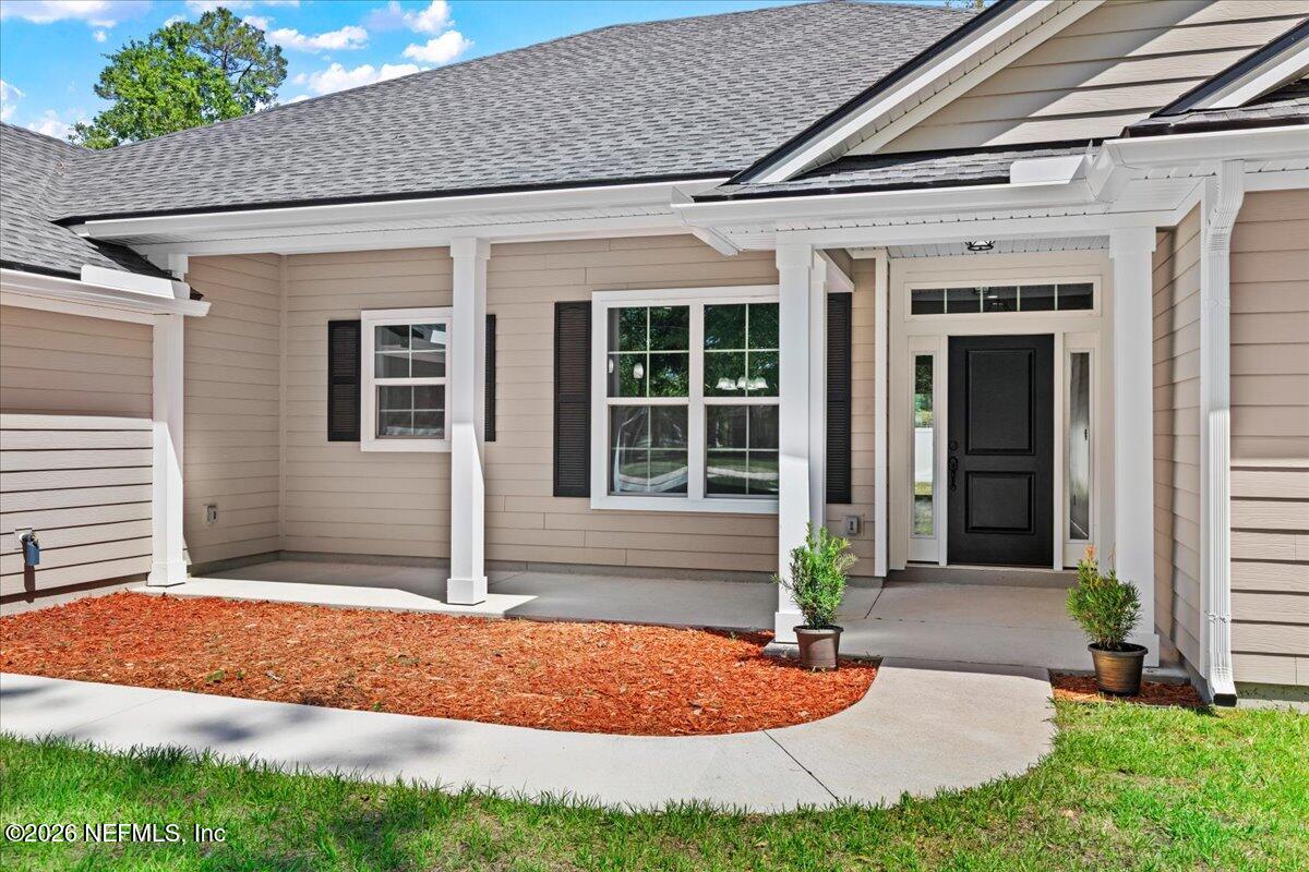 2462 Viola Street Middleburg, FL 32068 - Photo 3 of 61 a front view of a house with garden