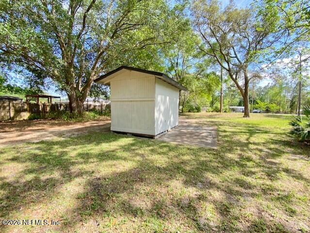 2462 Viola Street Middleburg, FL 32068 - Photo 53 of 61 a backyard of a house with a parked and tree