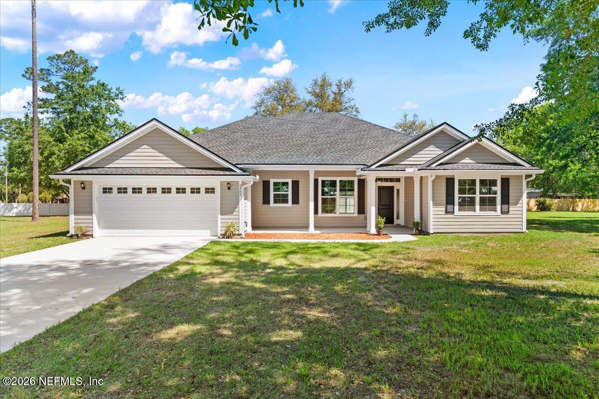 2462 Viola Street Middleburg, FL 32068 - Photo 54 of 61 a front view of a house with a garden