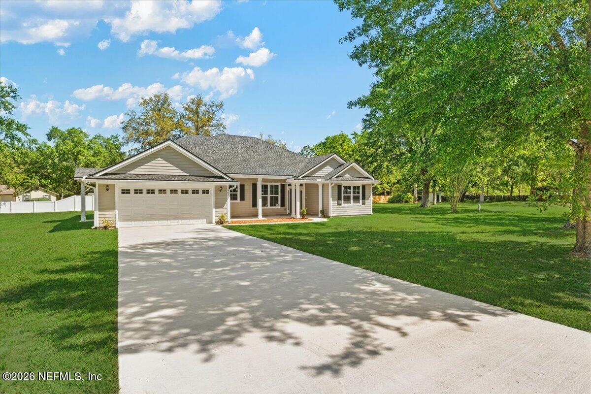 2462 Viola Street Middleburg, FL 32068 - Photo 56 of 61 a front view of a house with garden