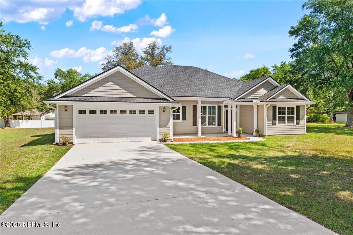 2462 Viola Street Middleburg, FL 32068 - Photo 58 of 61 a front view of a house with a garden