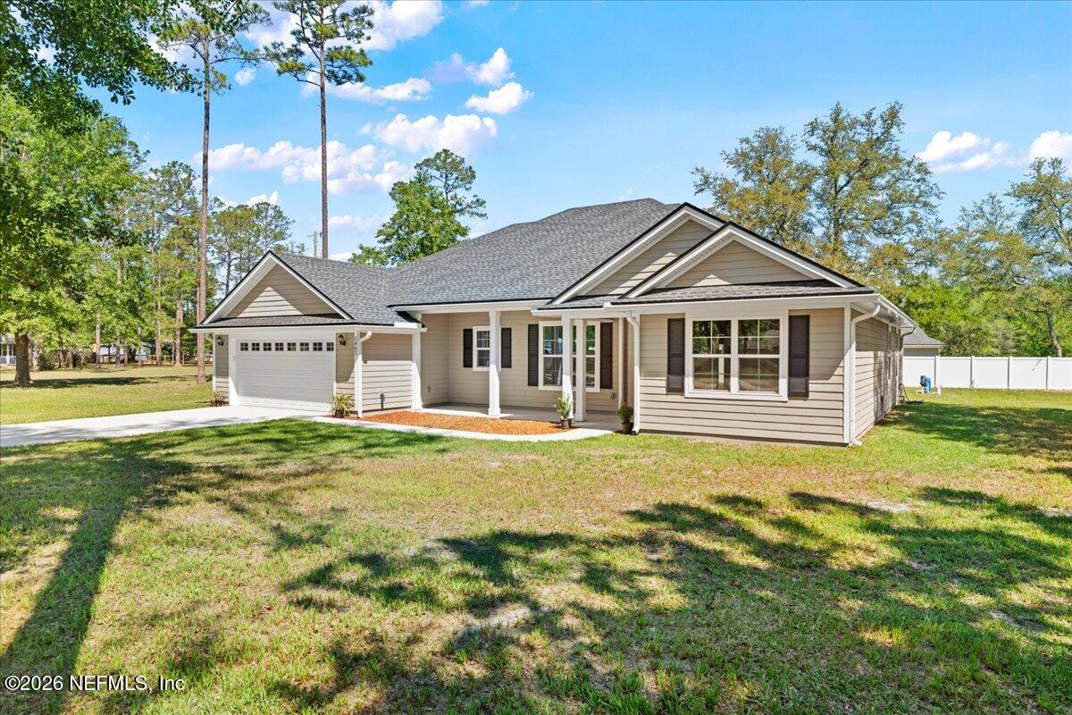 2462 Viola Street Middleburg, FL 32068 - Photo 59 of 61 a front view of a house with a garden