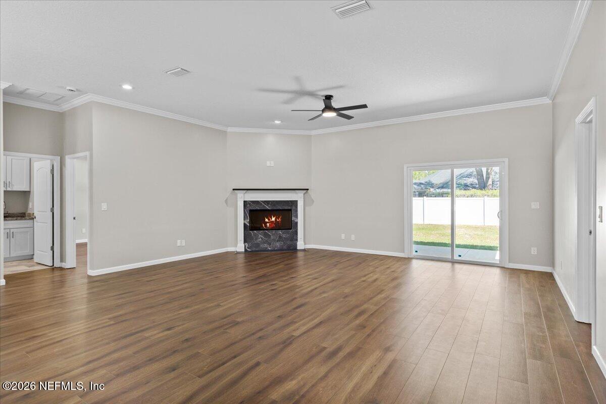 2462 Viola Street Middleburg, FL 32068 - Photo 8 of 61 a view of an empty room with wooden floor and a window