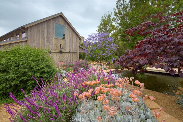 a backyard of a house with lots of green space and lake view