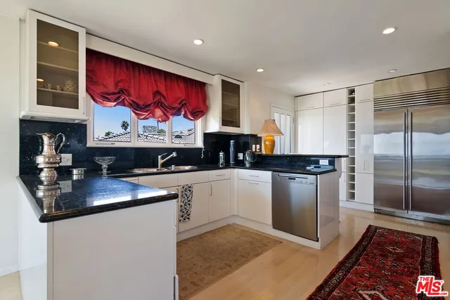 a kitchen with sink stove and cabinets
