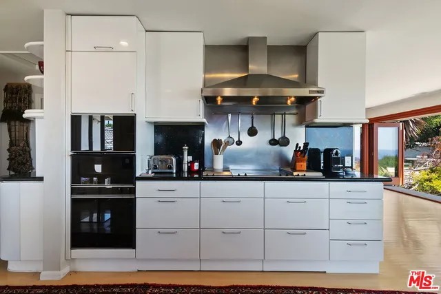 a kitchen with a sink cabinets and window