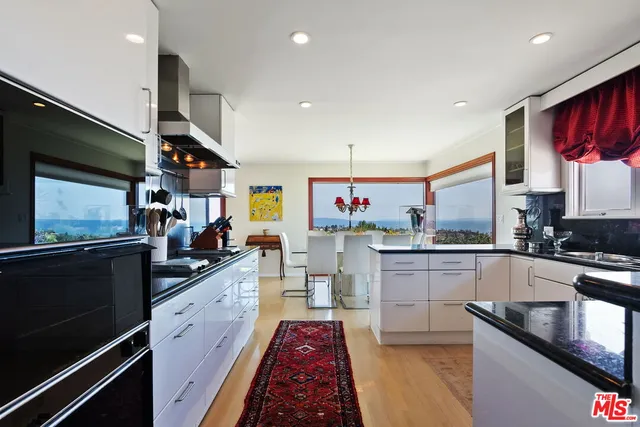a view of a patio with table and chairs potted plants with wooden floor and fence