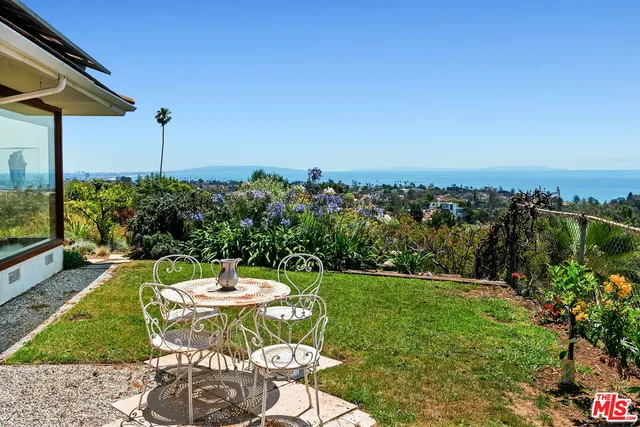 a living room with furniture a fireplace and a large window
