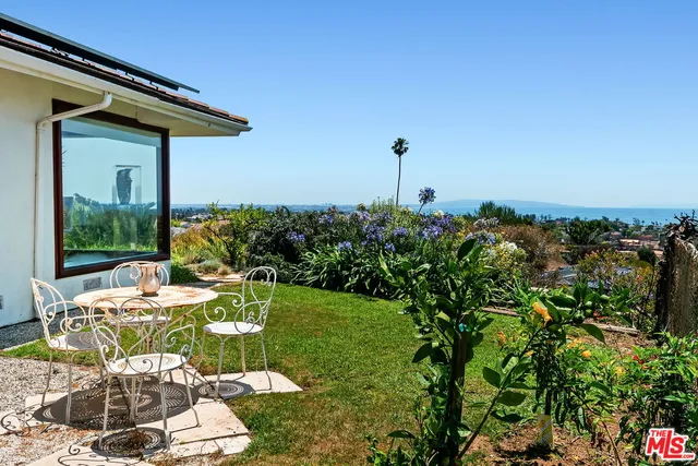 a outdoor living space with furniture and a floor to ceiling window