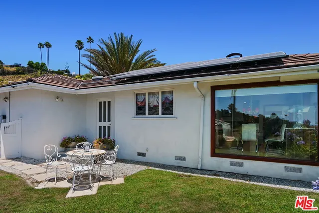 a view of a garden with a building in the background