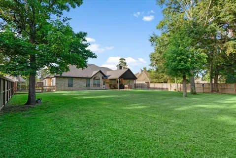 a view of yard with swimming pool and green space