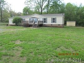 3843 Puetts Chapel Road Dallas, NC 28034 - Photo 1 of 7 a view of a house with a yard and a garden